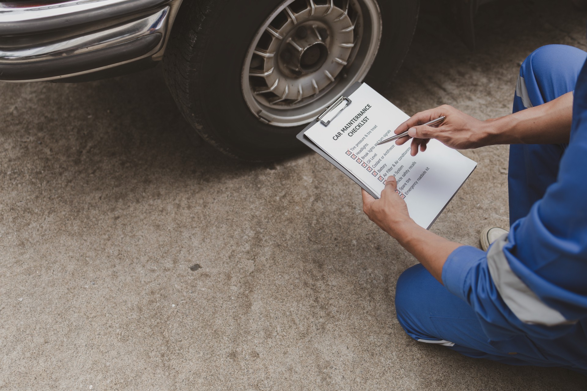 El mecánico de automóviles está inspeccionando neumáticos y reemplazando neumáticos desgastados a través de largas horas de trabajo, reparaciones de automóviles, averías de automóviles, neumáticos pinchados. Concepto de mantenimiento y reparació